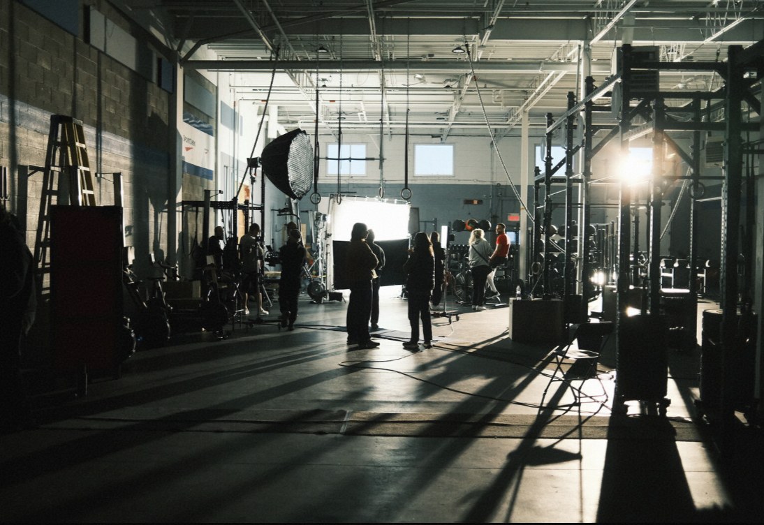 Crew setting up a shot in a sunlit gym